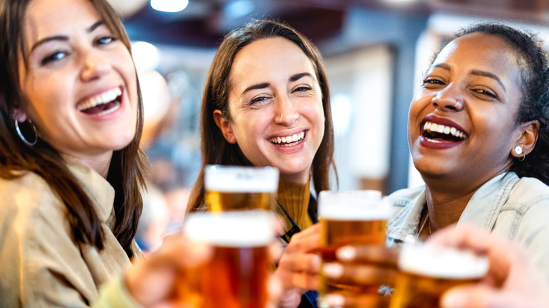 Women drinking beer and smiling