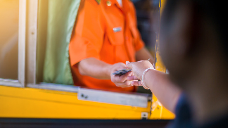 person paying toll at booth