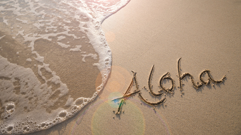 aloha written in sand