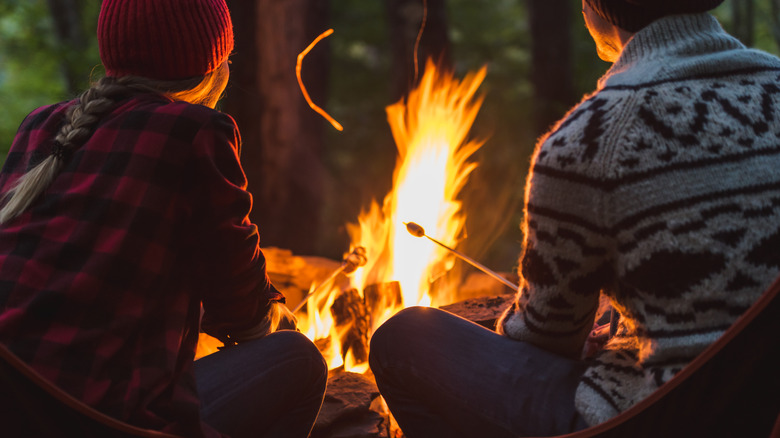 two people at a campfire 