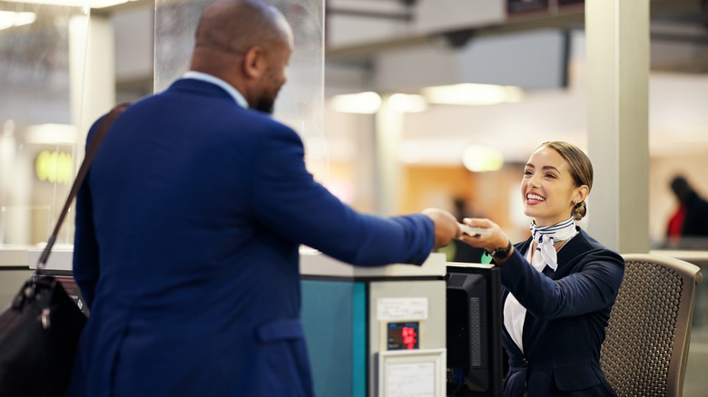 Man showing flight boarding pass