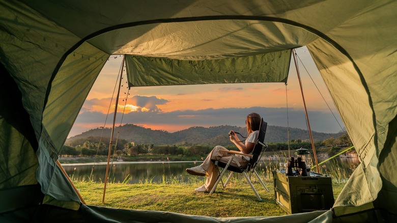 woman sitting outside of tent