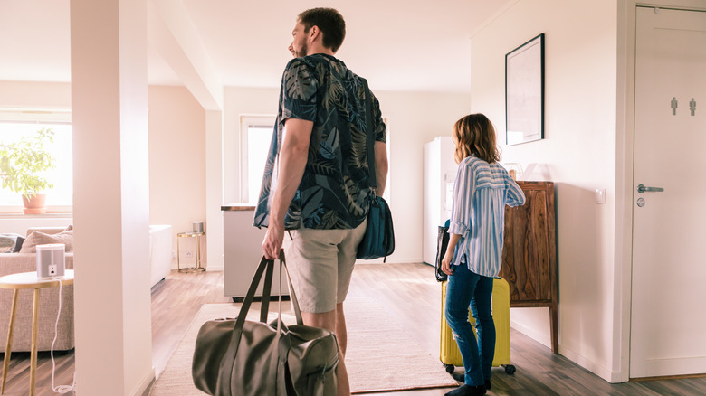 couple with luggage in room