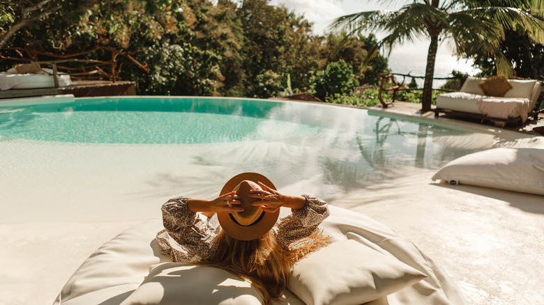 Woman relaxing by pool