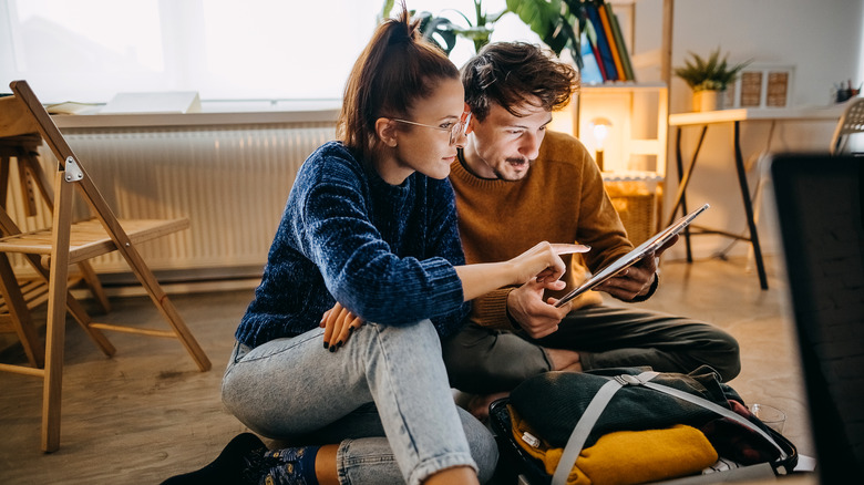 two people looking at tablet