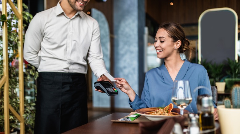 Woman paying with credit card