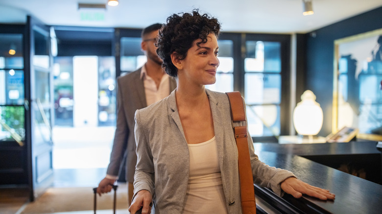 happy woman checking into hotel