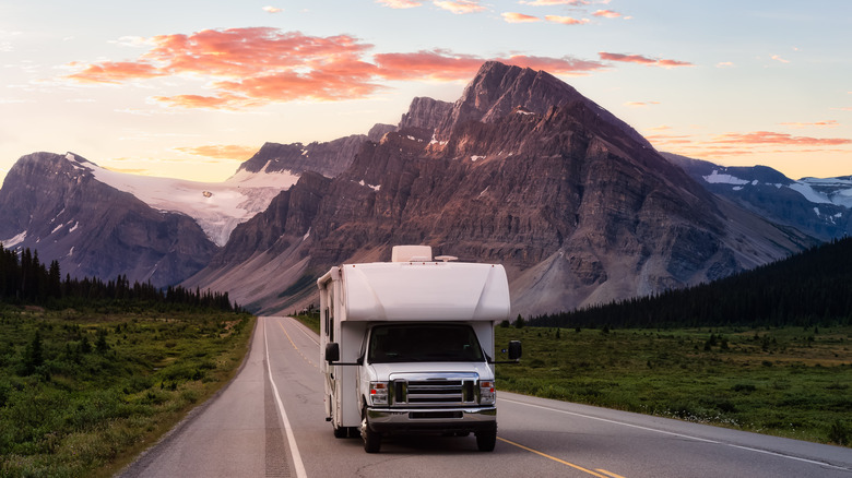 RV driving by a mountain