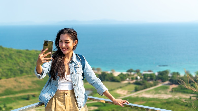 female traveler taking selfie