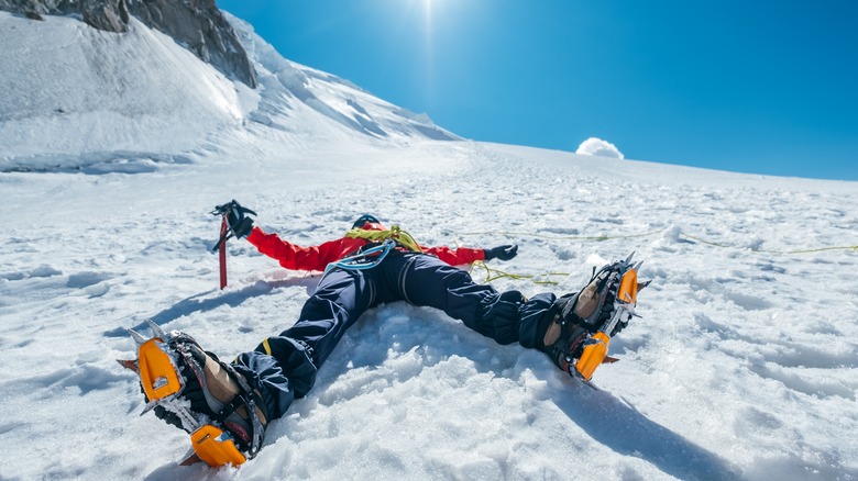 exhausted hiker laying in the snow