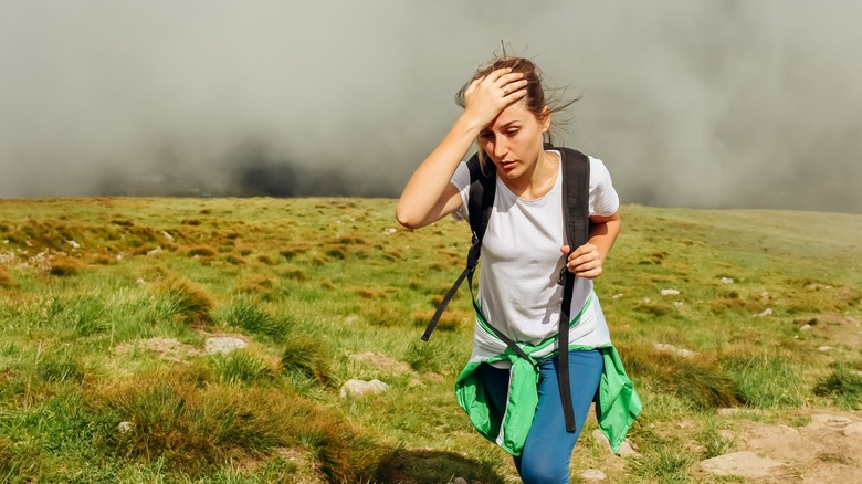 tired woman hiking mountain