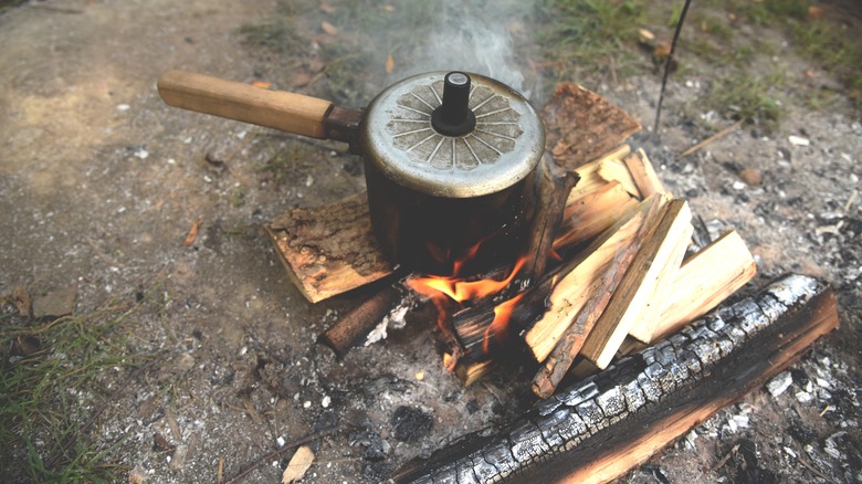 boiling water on campfire