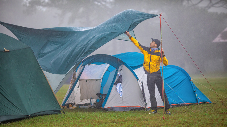 Woman zipping up a tent