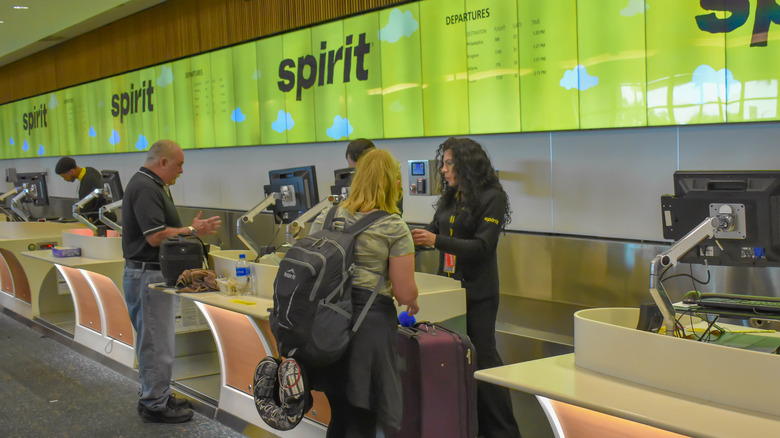 person checking luggage at Spirit