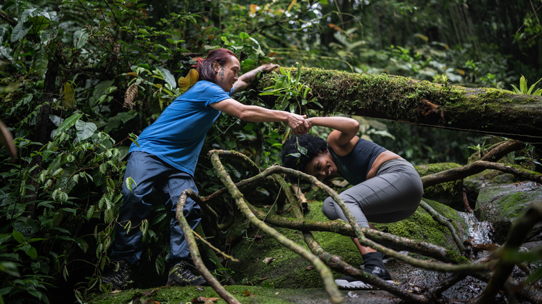 Two people being active in a jungle