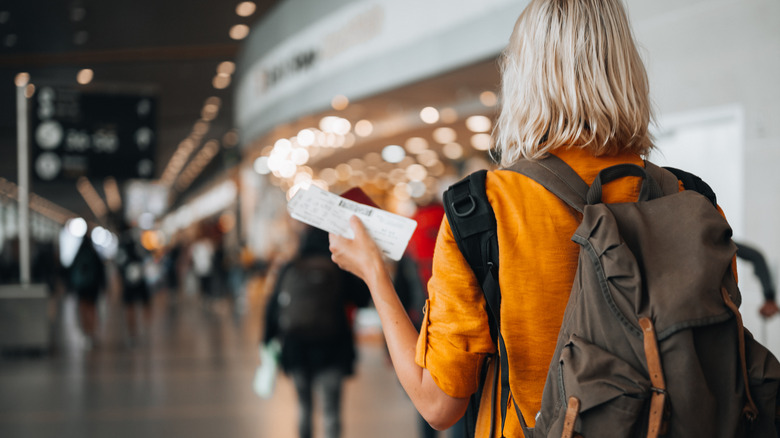 Woman holding ticket in airport