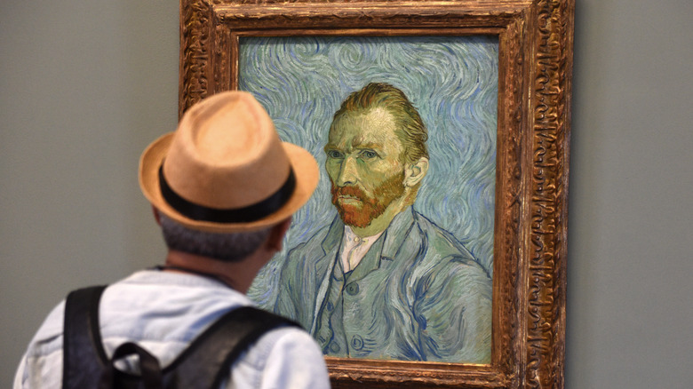 Man viewing van Gogh painting