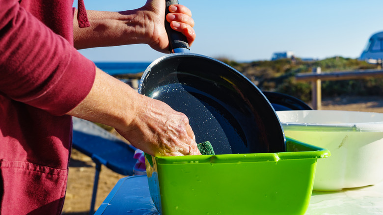 man washing dishes 