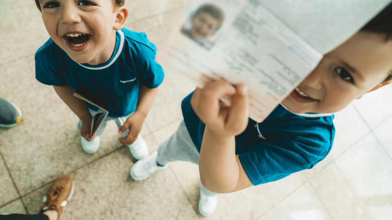 Children holding up their passports
