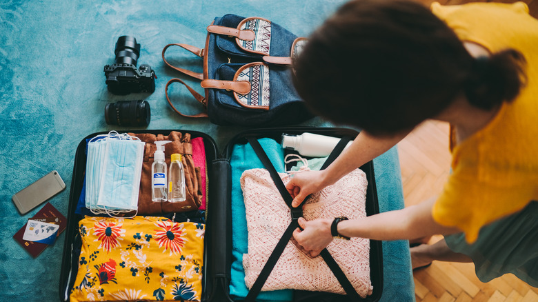 A woman packs for travel