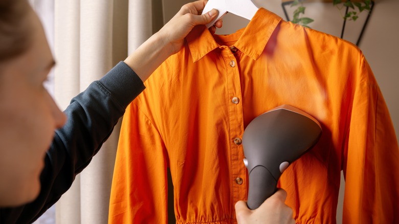 Woman steaming orange dress