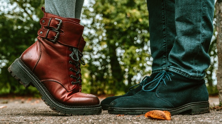 two people with lace-up boots