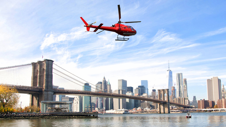 red helicopter flying over nyc