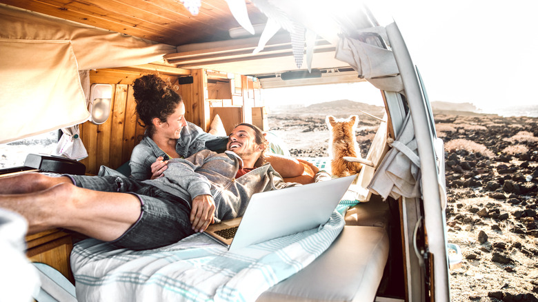 A couple in built-out van in nature