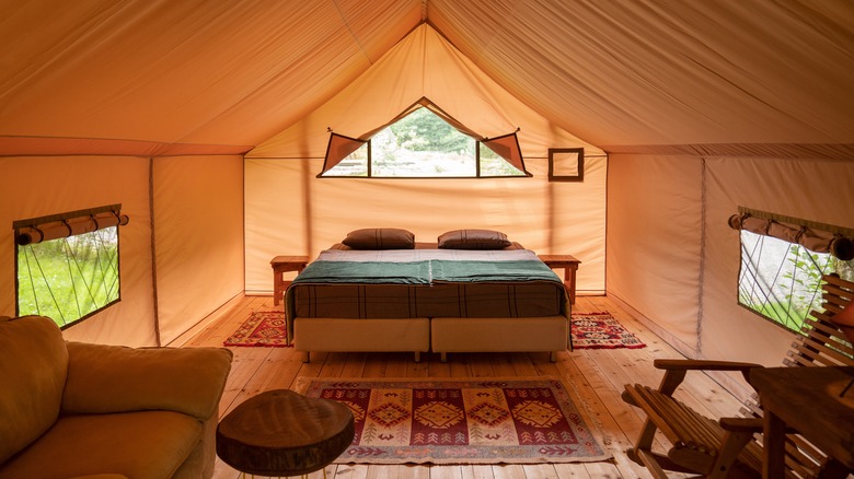 A bed and couch inside a yurt