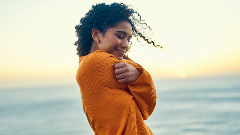 woman hugging herself