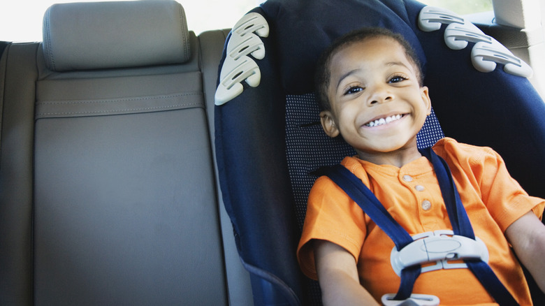 Child smiling in car seat