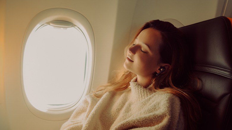 airplane passenger with eyes closed