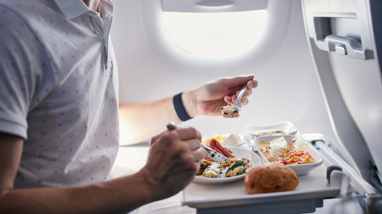 Man eating in-flight meal