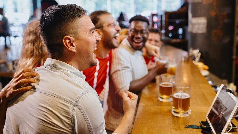 Football fans celebrating at a bar