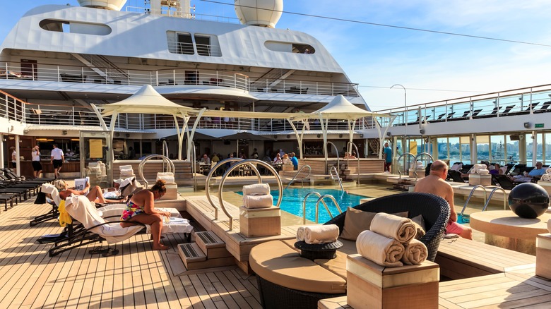 Cruise passengers in pool chairs