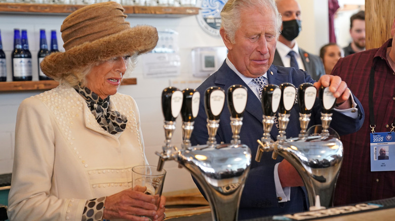 Camila Parker-Bowles and Prince Charles pouring a pint at Quidi Vidi Brewery 