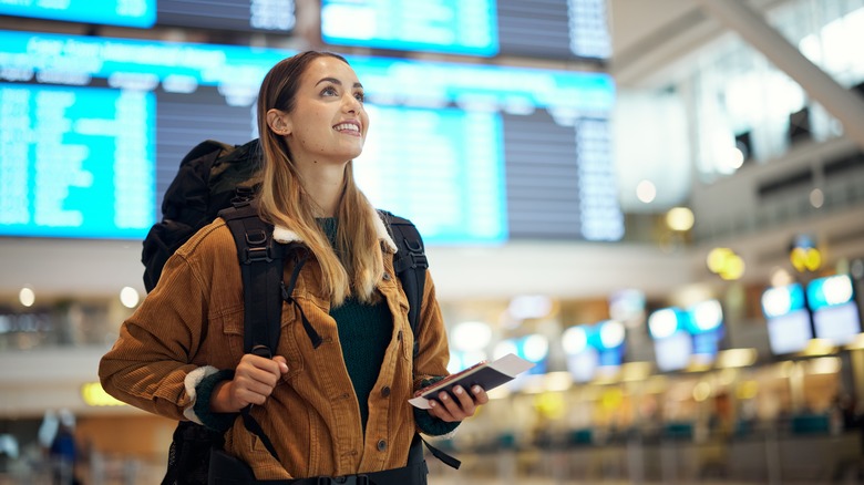 Backpacker checking flights 