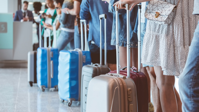 Passengers boarding flight with luggage