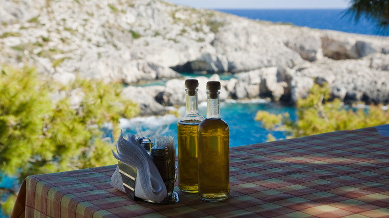 Olive oil bottles to scenic background