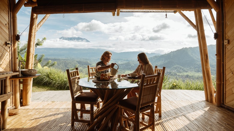 Couple having a meal in eco-lodge