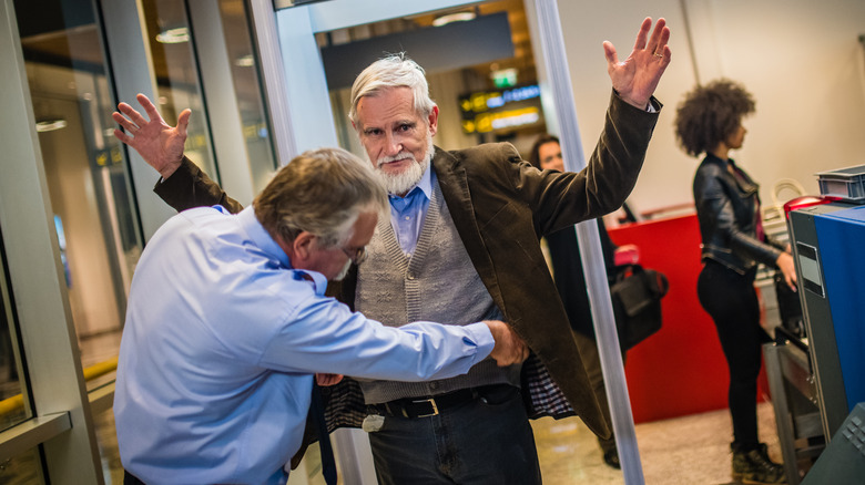 man during airport security check