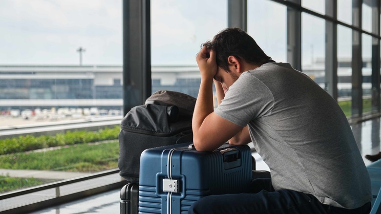 Frustrated traveler waiting by gate