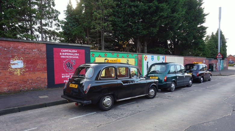 Black cabs parked in line