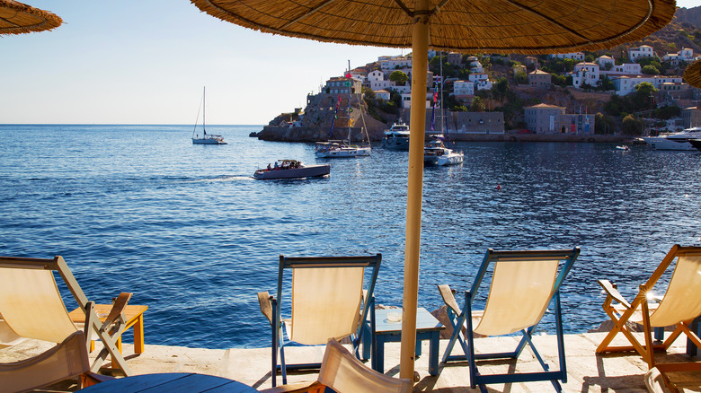 Shoreline chairs and boats in Hydra