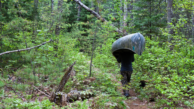 Person carrying canoe