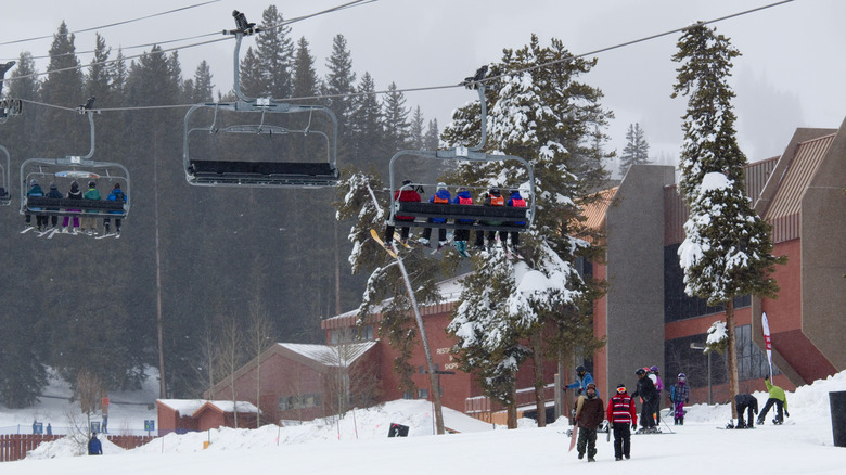 Skiers ride the lift in Breckenridge, Colorado