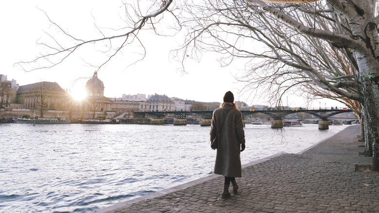 Woman walking Seine daytime