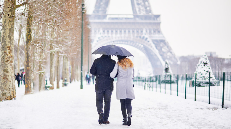 Couple walking near Eiffel Tower