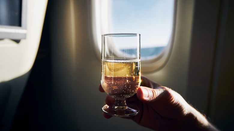 Wine glass and a plane window