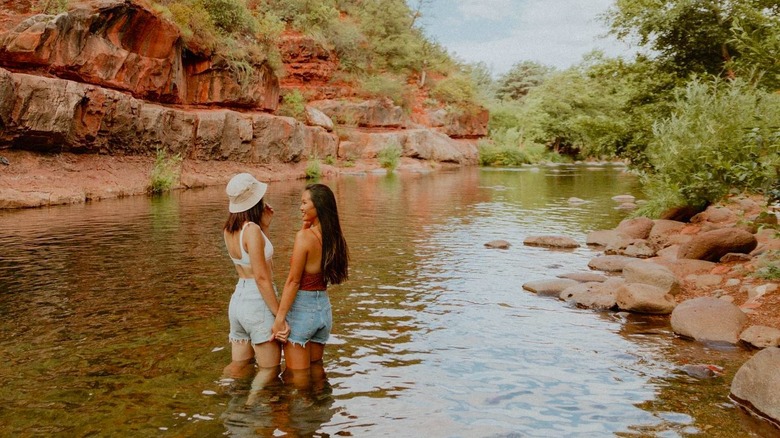 Two girls in rocky nature pool